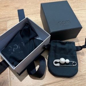 APM brooch